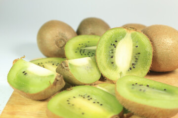 organic fresh juicy kiwi on wooden and white background.