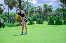 Woman Golfer Playing Golf On The Field