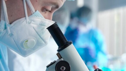 Wall Mural - scientist or researcher in laboratory looking into microscope