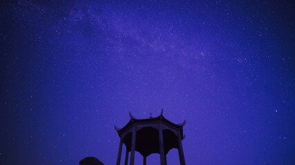 Wall Mural - Time-lapse of traditional pavilion under starry clear night sky