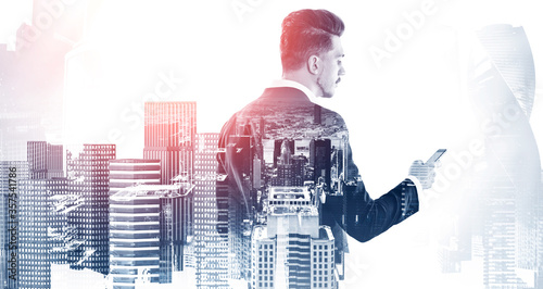 Businessman with smartphone in city Poster Mural XXL