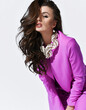 © Dmitry Lobanov - Portrait of hot excited brunette woman in bright purple pantsuit is leaning toward us