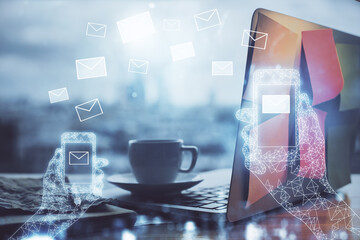 Desktop computer background in office and flying envelops hologram drawing. Multi exposure. Electronic mail concept.