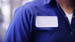 © Mose Schneider - Blue uniform shirt with empty name white patch, unrecognizable worker or employee Identification.