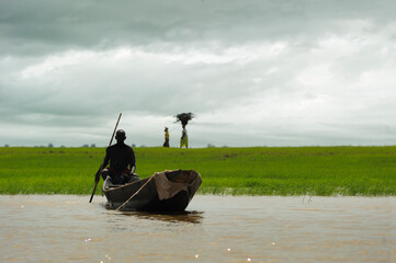 scene of fishermen on the barge on african river