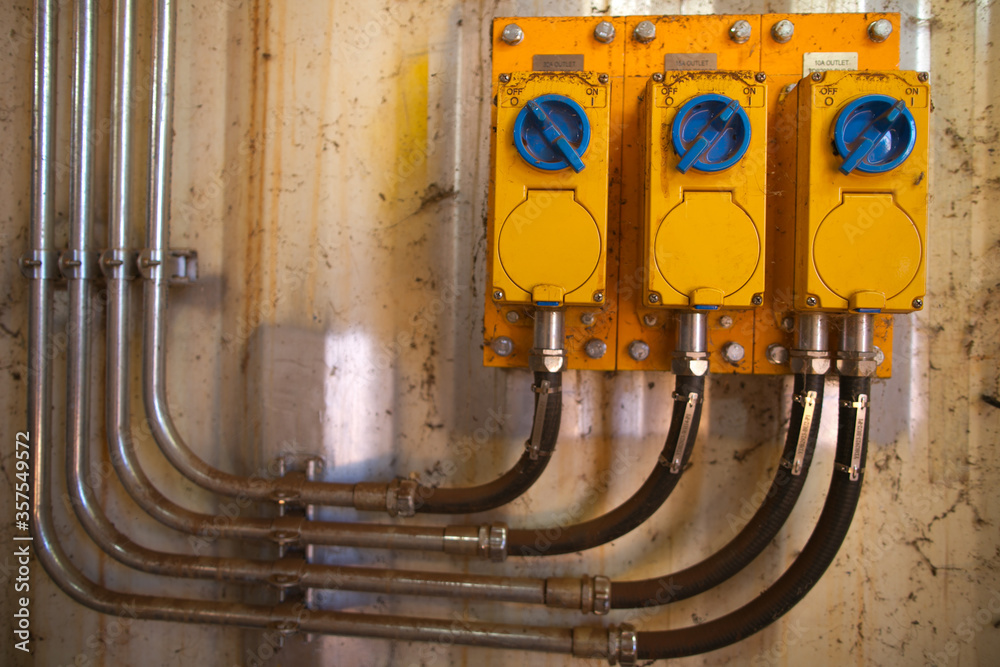 Yellow high voltage internal wall outlet power point at construction mine site Perth, Australia 