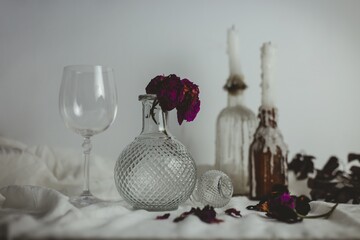 Sticker - Candles on the bottles next to a vase with a flower inside and a glass