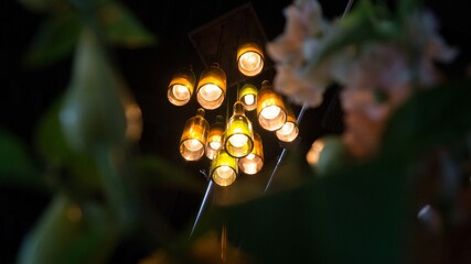 Sticker - Low angle shot of illuminated decorative light bulbs hanging on the ceiling