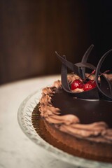 Poster - Vertical closeup shot of a chocolate cake with cherries on top