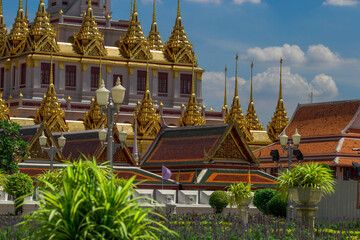 Background of tourist attractions where people come to see the beauty of the architecture of the golden pagoda in Bangkok (Wat Metal Prasat Or Wat Ratchanaddaram Worawihan) in Thailand