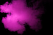 Colorful smoke close-up on a black background. Blurred pink cloud of smoke.