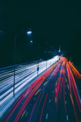 Poster - Aerial shot of a dark highway with traffic light trails