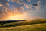 Fototapeta Natura - Beautiful lnadsape image of field of barley crop at sunset in English countryside with dramatic sky