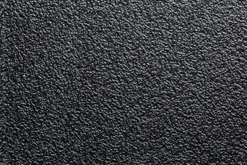 flat black rugged plastic or rubber surface with decorative bumpy finish