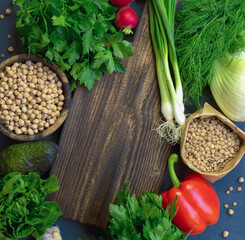 The concept of a healthy diet and organic food. Cooking salads. Ingredients next to a cutting board