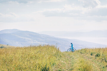 Sticker - Woman walking on path among green grass meadow.