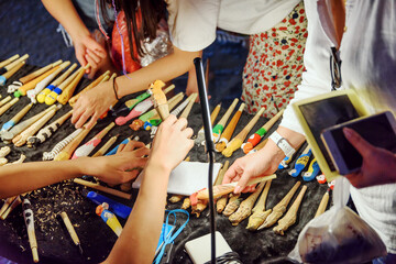 Tourists choosing wooden carved handmaid souvenirs, Yangshuo