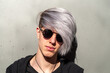 © Pere Chuliá - Portrait of young adult with sunglasses, outdoors and with silver-tinted hair.