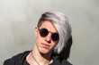 © Pere Chuliá - Portrait of young adult with sunglasses, outdoors and with silver-tinted hair.