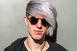 © Pere Chuliá - Portrait of young adult with sunglasses, outdoors and with silver-tinted hair.