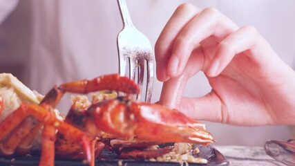 Poster - A girl peeling a lobster shell and eating lobster
