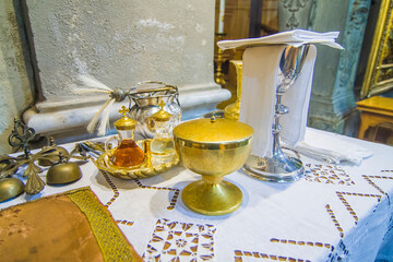 Wall Mural - chalice for wine, blood of christ, and ciborium with host, body of christ, and ampoules with wine and water for consecration