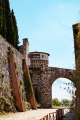 Wall Mural - A medieval fortress (castle) with watchtowers, a trench and a walk-in bridge in front of the entrance made of white stones (bricks) in the center of the Italian city of Brescia (Lombardy, Italy).