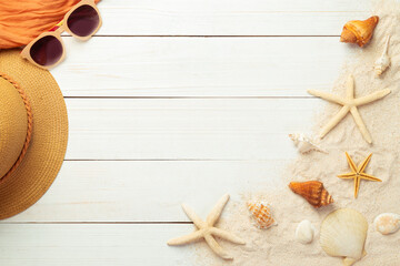 Summer background with beach accessories - straw hat, sunglasses, towel on white wood table background top view with copy space.