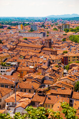 Wall Mural - Aerial view of the historical center of Brescia (Lombardy, Italy) with tiled red roofs, chimneys, cathedral's domes and tall white brick old towers. Traditional European medieval architecture. 