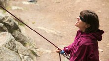 Women Belaying A Rock Climber