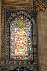 Sticker - Vertical shot of a window with colorful stained glass in the mosque