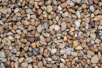 Grey, orange, beige, and white pebbles. Warm background with stone textures.