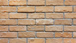 close up of old brick wall, old texture of orange stone blocks.