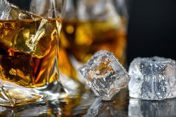 Sticker - Glass of whiskey with cube ice on black background