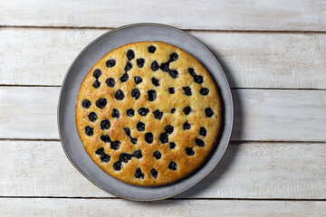 Wall Mural - Cherry pie on gray plate on white wooden background