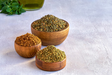 Wall Mural - Mixed spice zaatar or zatar in wooden bowls, Various type of zaatar blend. Close up with copy space	