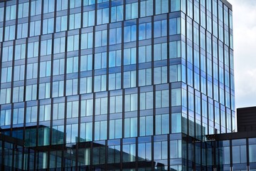 Facade texture of a glass mirrored office building. Fragment of the facade. Modern architecture of the office building.