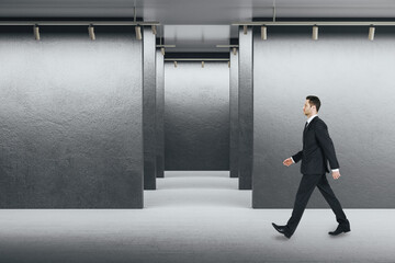 Aufkleber - Businessman walking in exhibition interior with blank  wall