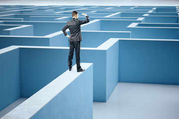 Poster - Businessman in suit standing on middle of a blue labyrinth.