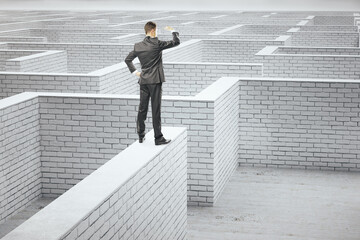 Poster - Young businessman standing on white brick labyrinth.
