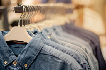 Modern fashion women clothes hang on stanless steel hangers rack at department store.