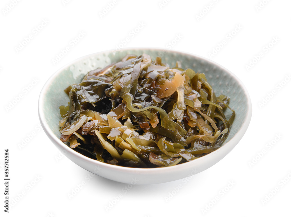 Bowl with tasty seaweed on white background