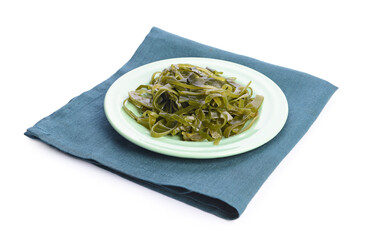 Plate with tasty seaweed on white background