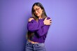 © Krakenimages.com - Young beautiful smart woman wearing glasses over purple isolated background Hugging oneself happy and positive, smiling confident. Self love and self care