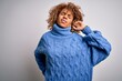 © Krakenimages.com - Young beautiful african american woman wearing turtleneck sweater over white background Suffering of neck ache injury, touching neck with hand, muscular pain