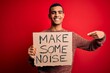 © Krakenimages.com - Handsome african american activist man protesting holding banner with make noise message very happy pointing with hand and finger