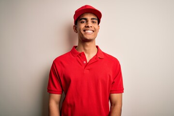 Wall Mural - Young handsome african american man wearing casual polo and cap over red background with a happy and cool smile on face. Lucky person.