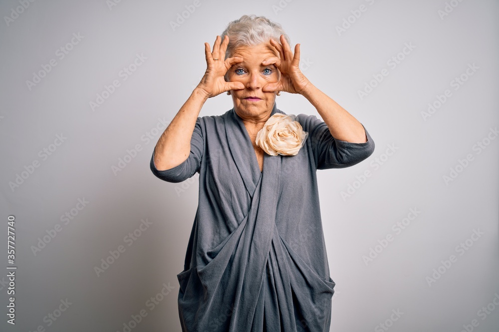 Senior beautiful grey-haired woman wearing casual dress standing over white background Trying to open eyes with fingers, sleepy and tired for morning fatigue - obrazy, fototapety, plakaty 