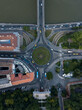  Aerial view of roundabout city traffic near Szechenyi Chain Bridge and Parliament building. Cars drive on circle road and riverside road. Historic architecture buildings. Budapest, Hungary, Europe 