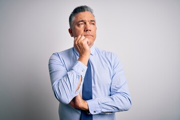 Sticker - Middle age handsome grey-haired business man wearing elegant shirt and tie with hand on chin thinking about question, pensive expression. Smiling and thoughtful face. Doubt concept.